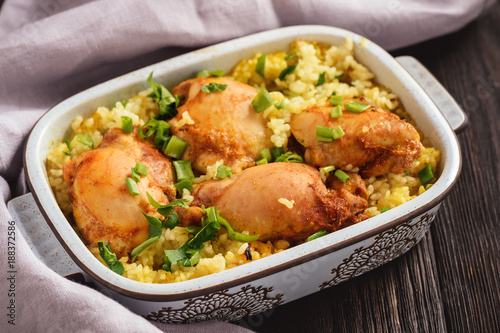 Oven baked chicken meat with rice.