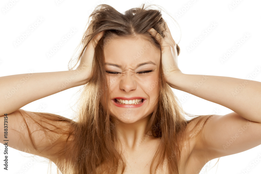 very nervous young girl with messy hair on a white background