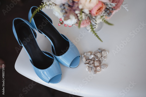 Elegant wedding flower bouqet on texture background with bridal shoes tiffany colour photo