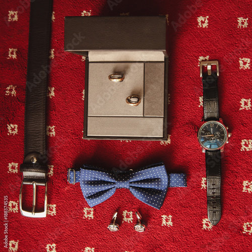 Wedding details. Groom accessories. Shoes, rings, belt, and bowtie photo