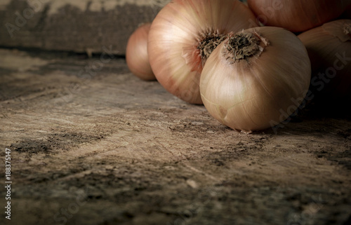 Onions on Vintage Wood Table Background, Rustic Style.