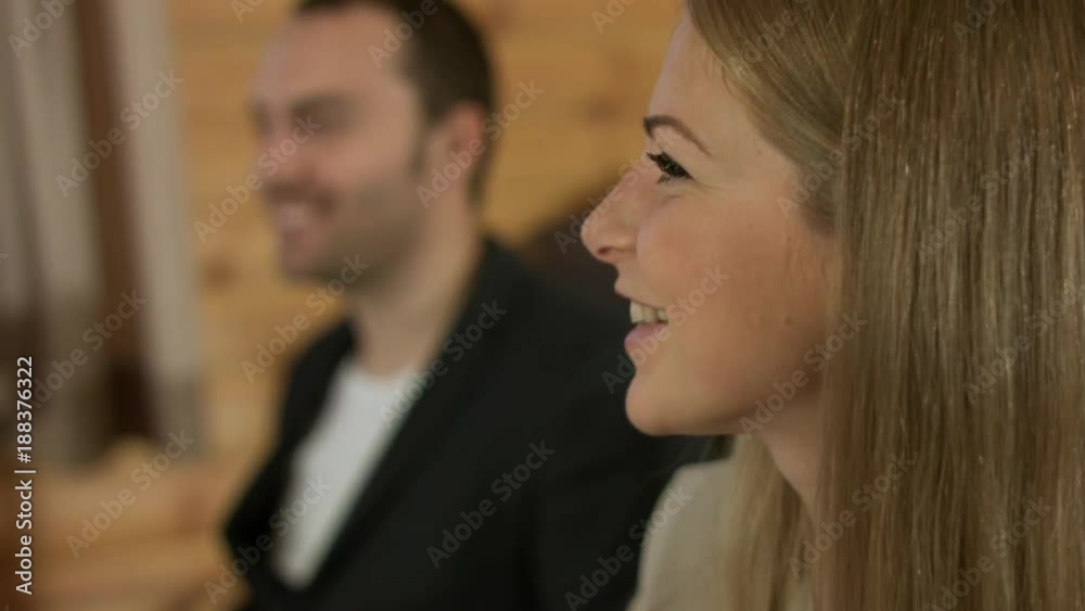 Blonde woman communicates with friends, smiles and laughs Blonde woman communicates with friends, smiles and laughs
