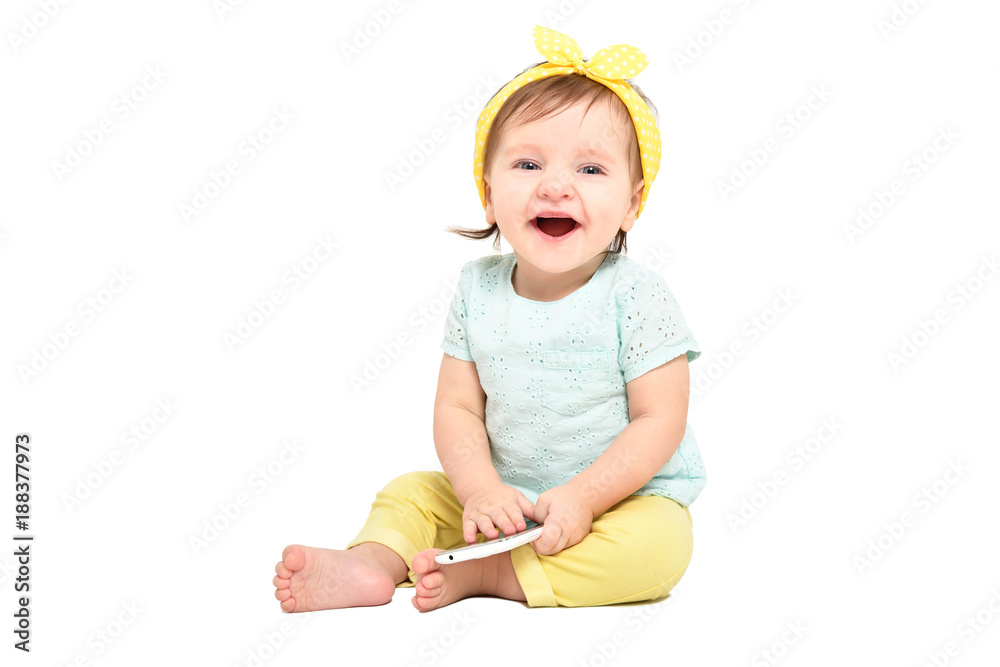 Cute laughing baby girl, sitting with a mobile phone, isolated on white background
Cute laughing baby girl, sitting with a mobile phone, isolated on white background