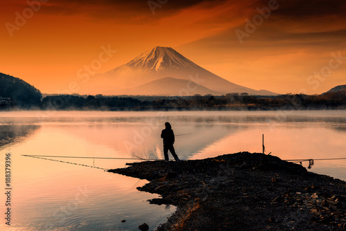 fishing at Lake against mt. fuji at dawn