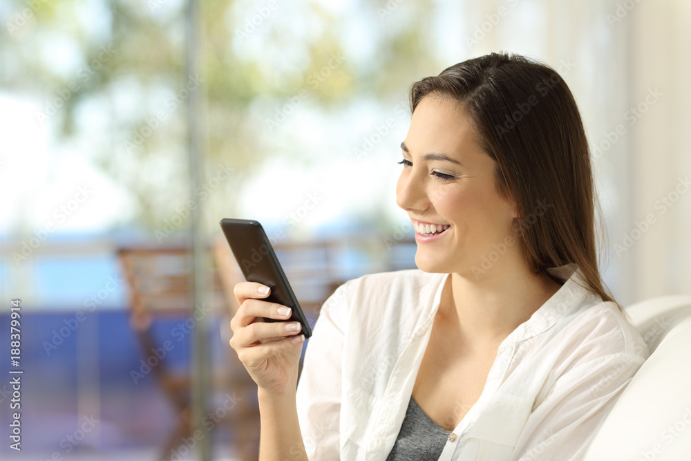 Woman using a smart phone in an apartment