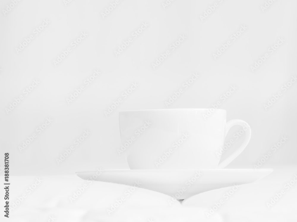 Black and white tone of coffee cup, white floor and grey wall.
