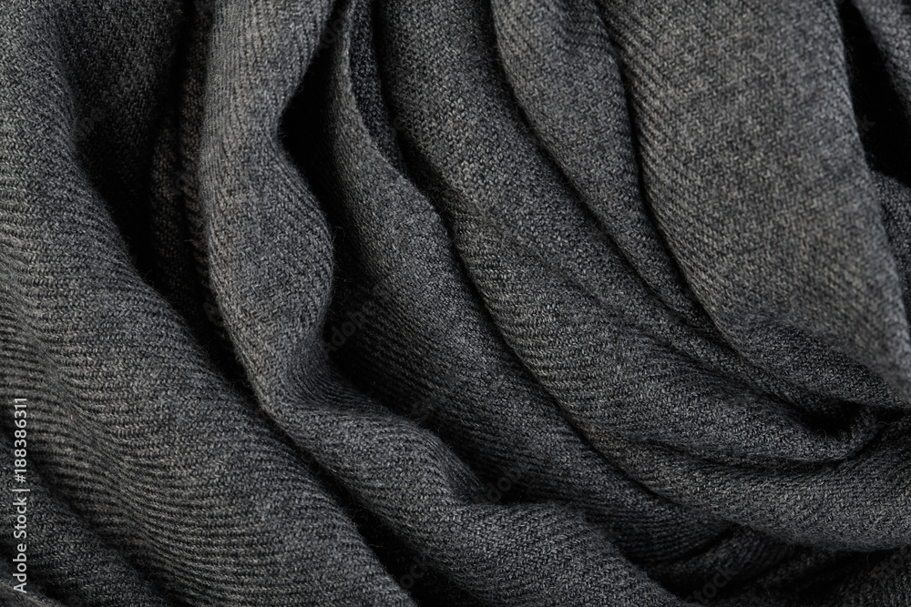 knitted woolen fabric texture, abstract background. Close-up of jersey fabric textured cloth background. Close up on crumpled gray material texture fabric. Grey textile pattern as a background. knitted woolen fabric texture, abstract background. Close-up of jersey fabric textured cloth background. Close up on crumpled gray material texture fabric. Grey textile pattern as a background.