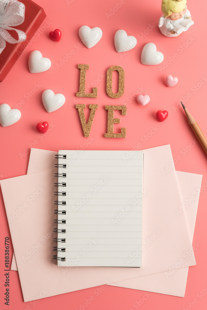 Flat view of notepads in the centre of valentines hearts and decoration on pink background with copy space. Symbol of love. Happy Valentines Day background.Saint Valentine's Day concept. Flat view of notepads in the centre of valentines hearts and decoration on pink background with copy space. Symbol of love. Happy Valentines Day background.Saint Valentine's Day concept.