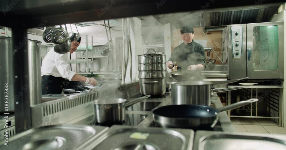 chef actively working in the kitchen of an Asian restaurant, 4K slow motion chef actively working in the kitchen of an Asian restaurant, 4K slow motion
