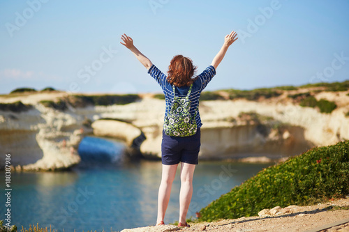 Girl enjoying view to sea coast in Sardinia, Italy