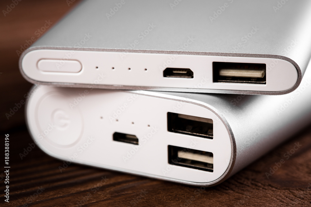 battery bank for charging mobile devices. Silver smart phone charger with power bank. External battery for mobile devices. battery bank for charging mobile devices. Silver smart phone charger with power bank. External battery for mobile devices.