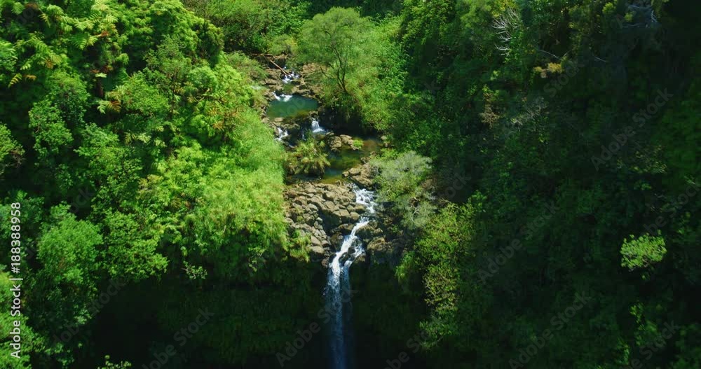 Cinematic aerial view of beautiful waterfall in Hawaii