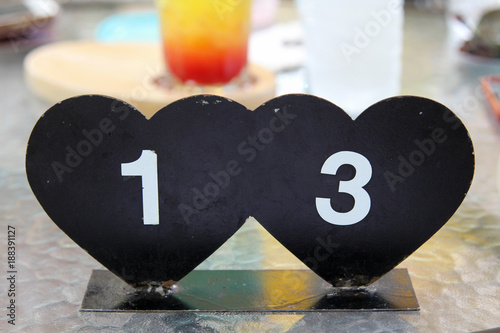 Black metal heart shaped table sign. photo