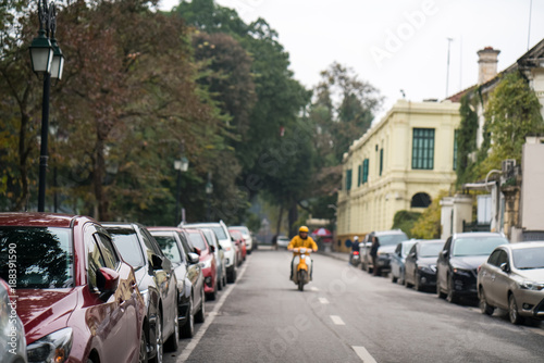 Cars parked on the urban street side © Hanoi Photography