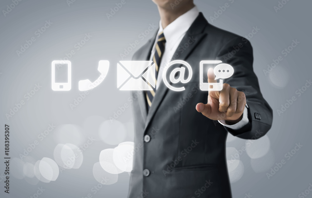 Customer service, call center service or contact us concept Businessman touching communication icons (mobile phone, telephone, mail, email address, social media) on bright tone background. Customer service, call center service or contact us concept Businessman touching communication icons (mobile phone, telephone, mail, email address, social media) on bright tone background.