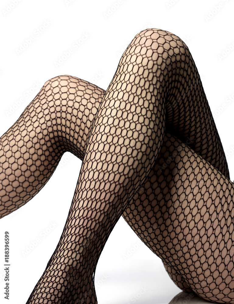 close-up of crossed legs with fishnet stockings Stock Photo