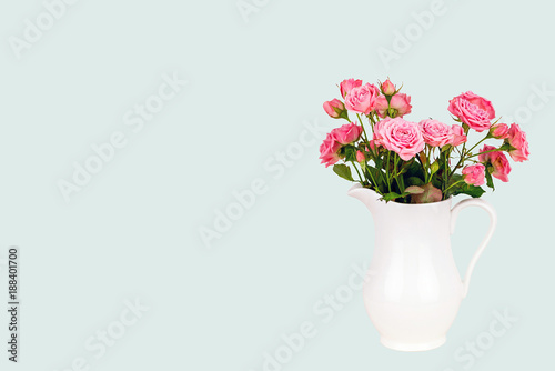Pink flowers in white jug.