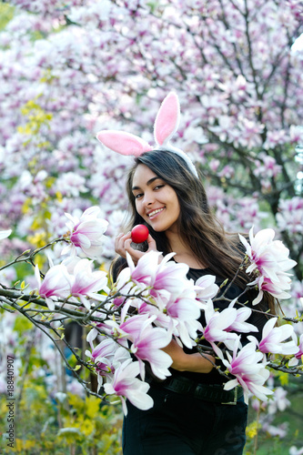 egg in hand of happy woman with plush lips, magnolia