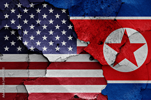flags of United States and North Korea painted on cracked wall