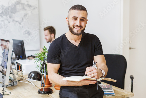 Portrait of young man working at office