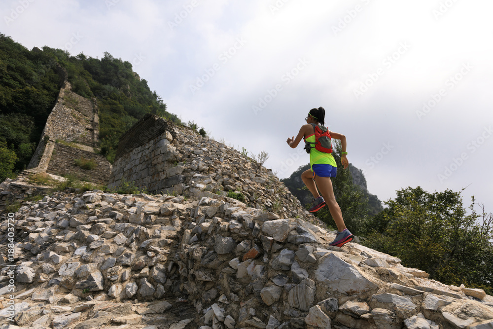 running woman trail runner on the great wall top of mountain