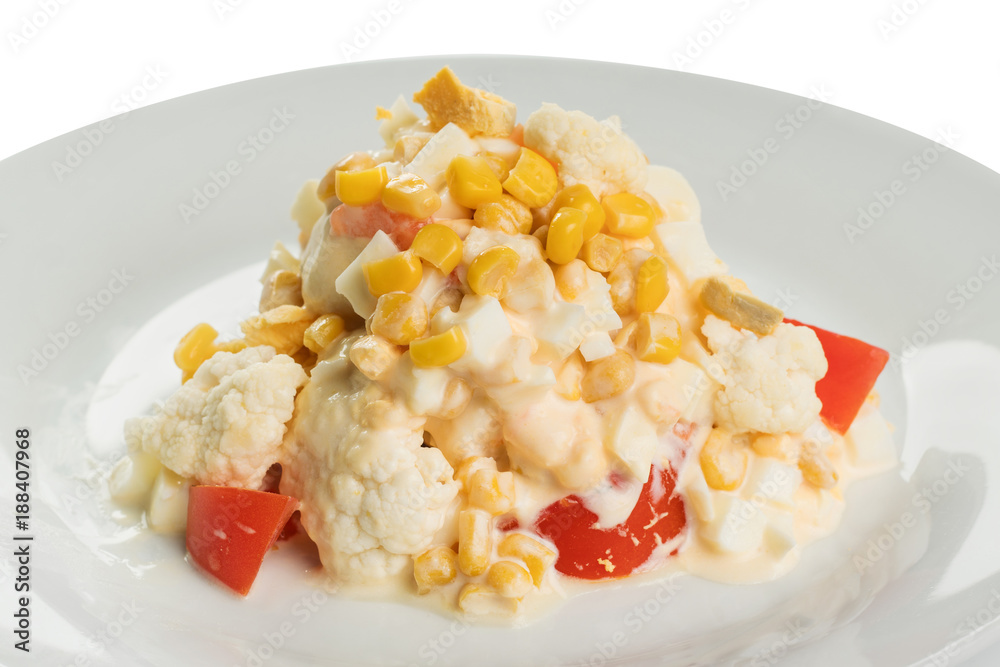 salad of cauliflower with fresh tomato and corn, with mayonnaise on a white plate salad of cauliflower with fresh tomato and corn, with mayonnaise on a white plate