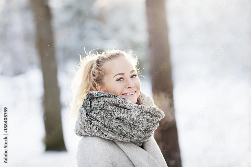 Blond woman in winter landscape smiling at camera Blond woman in winter landscape smiling at camera