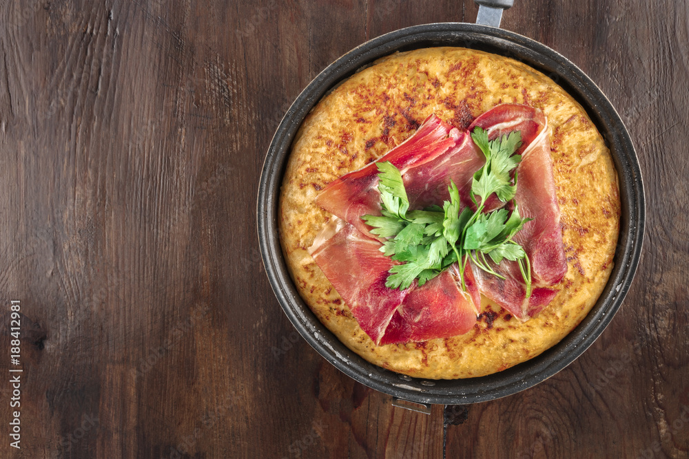 Overhead closeup photo of Spanish tortilla with copy space