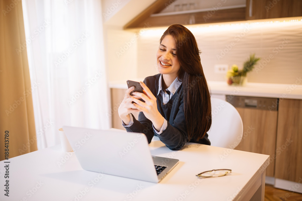 Business girl while smile on her face typing messages on her phone.