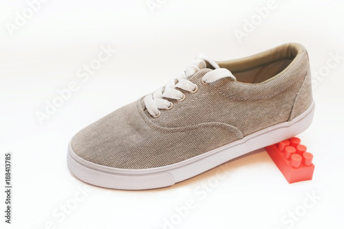 Sports shoes of coffee color on a white background
