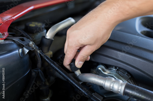 close up hand of auto mechanic checking car engine,worker