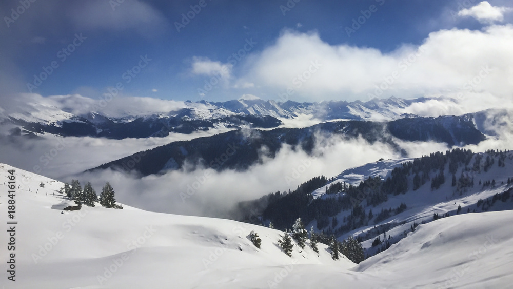 Snow covered Alps with clouds in the valley