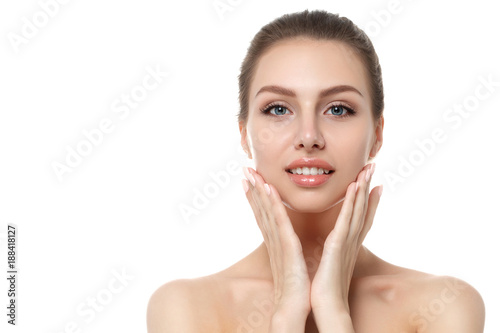 Portrait of young beautiful woman touching her face