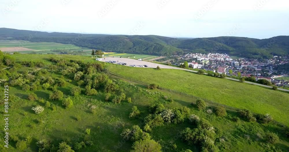 Beautiful scenery of the Braunsberg hill with the view towards the parking lot on the very top of the mountain, including cars and bicycles with Hainburg,Austria and the river Danube in the background Beautiful scenery of the Braunsberg hill with the view towards the parking lot on the very top of the mountain, including cars and bicycles with Hainburg,Austria and the river Danube in the background