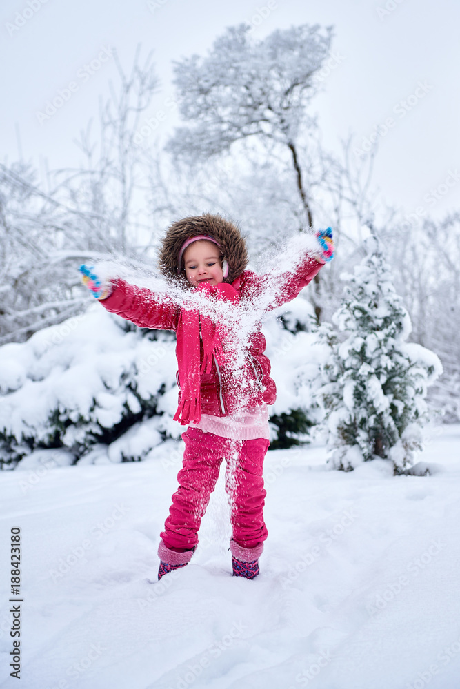 Little girl in red clothes, playing on snow Little girl in red clothes, playing on snow