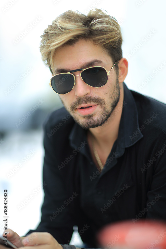 Businessman sitting in park using mobile phone