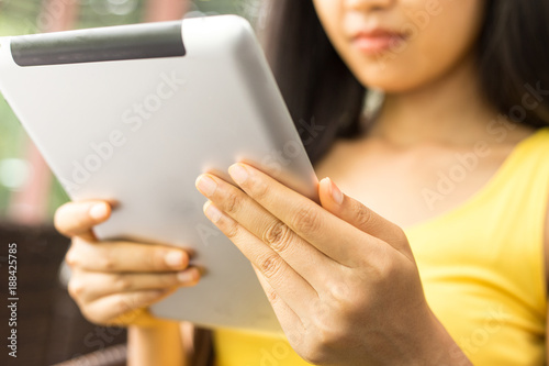 A woman is using a tablet.