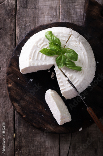A fresh ricotta with basil leaf on wooden table italian food concept