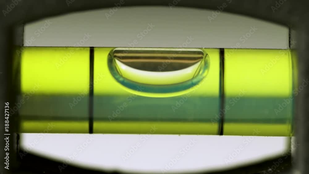 Spirit Level Close Up. Green bubble level isolated on a white background.
