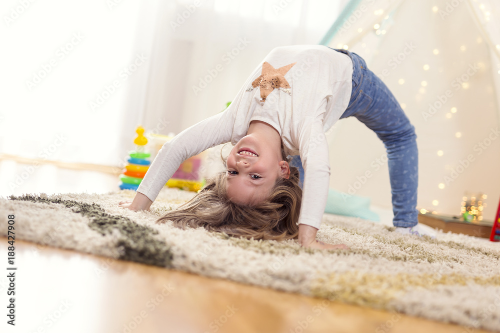 Little girl doing backbend Stock Photo | Adobe Stock