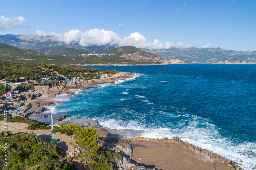 Aerial view of the coast of Montenegro. Storm waves on the Ploče beach.