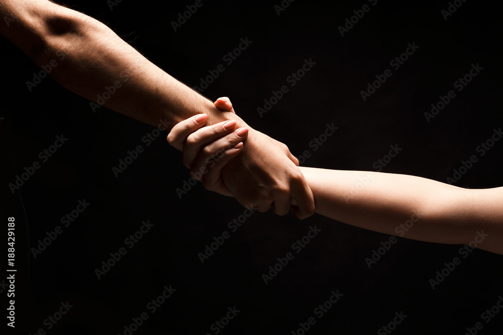 Hands of man and woman in love, isolated on black