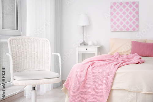 Elegant bedroom interior with white armchair © Africa Studio