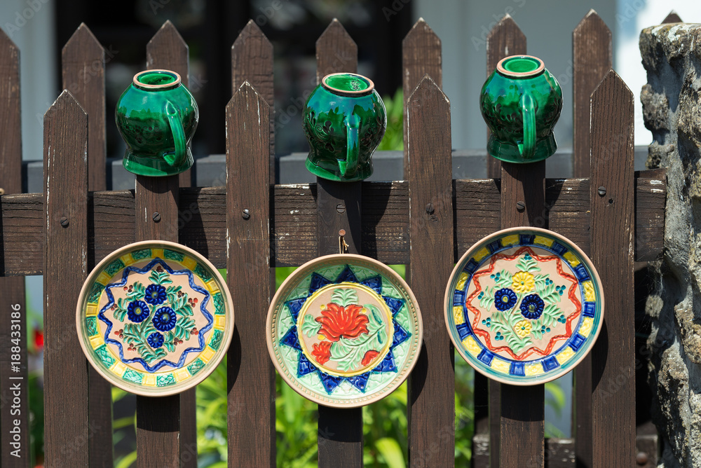 Hand-made crockery dryed on fence