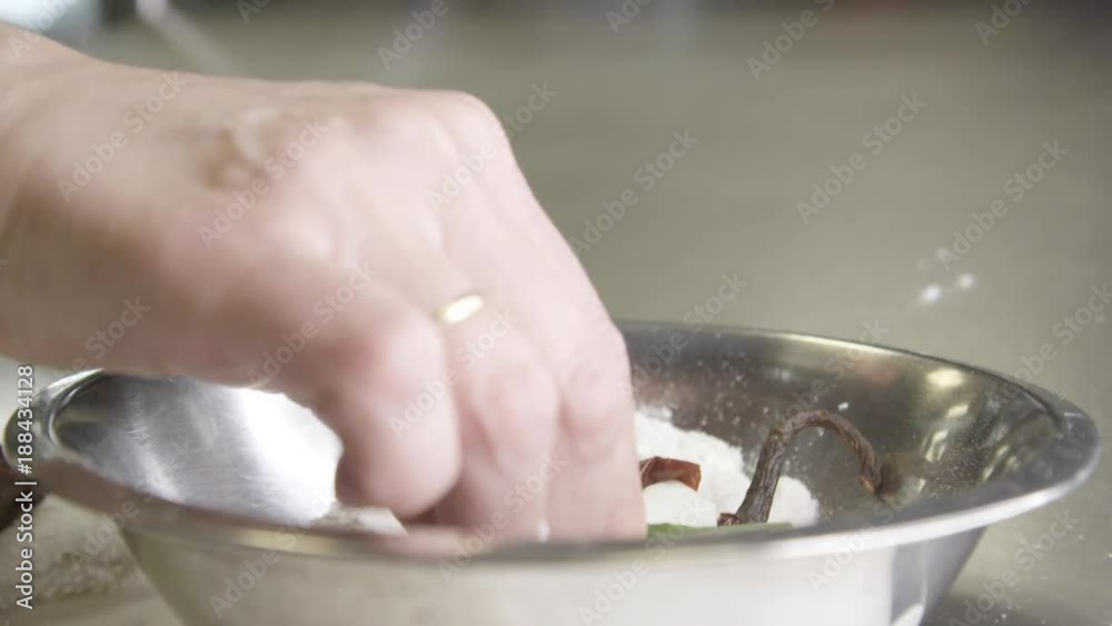 Slow motion, chef puts pepper in flour Slow motion, chef puts pepper in flour
