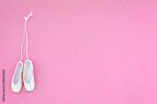 Ballet pointe shoes on pink background top view copy space photo