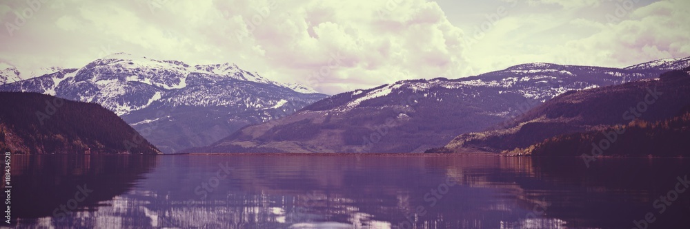 Composite image of snowcapped mountains and a lake 