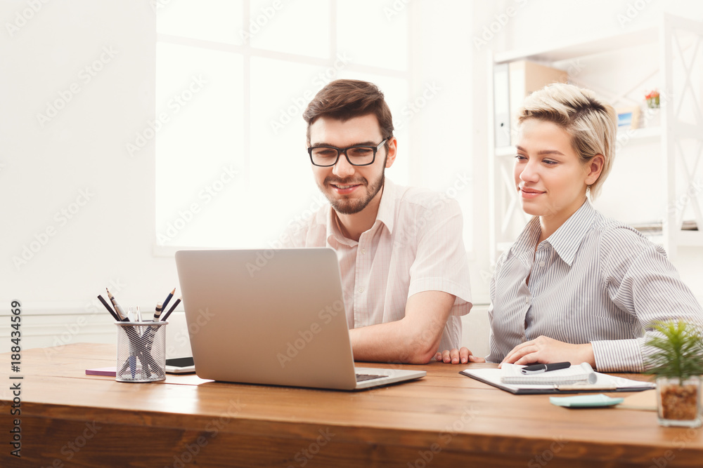Couple of young colleagues working at modern office Couple of young colleagues working at modern office