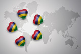 five hearts with national flag of mauritius on a world map background.