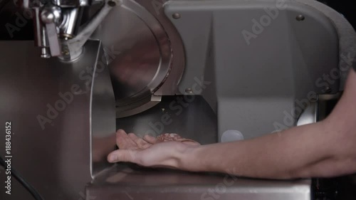 Catching deli slices from meat cutter, close up